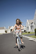 Full length portrait of a young girl riding bicycle on street