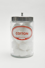A Glass Bottle With Cotton Isolated Over White Background