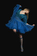 © MDBPIXS - Full length of a woman dancing against black background
