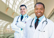 © Andy Dean - African American and Caucasian Male Doctors Inside Hospital Office.