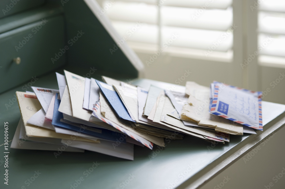 Closeup of letters on writing desk at home - obrazy, fototapety, plakaty 