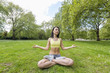 © MDBPIXS - Full length of beautiful fit woman performing yoga at park