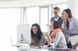 © MDBPIXS - Smiling businesspeople working together at conference table