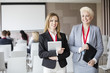 © MDBPIXS - Portrait of confident businesswomen standing in seminar hall