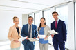 © MDBPIXS - Portrait of smiling business people with documents in office