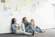 © MDBPIXS - Tired businesswomen sitting on floor in creative office