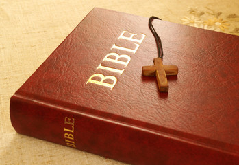 Red Bible book and wooden cross