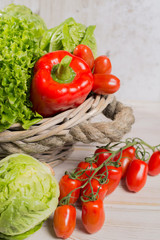 Variety of green and red fresh lettuce salad leaves, red paprika