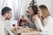 © nikodash - Friend sharing pizza for New Year eve. Christmas dinner at home