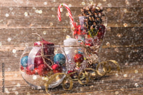 Glass Vase With Christmas Decorations On Wooden Background