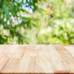 Wall Mural - Rubber wood tabletop texture square with blurry nature leaf back