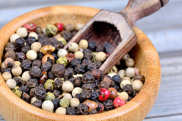 Bamboo bowl with colorful peppercorns