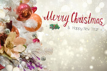 Christmas White Tree With Holiday Red And Orange Decorations And Lights With Copy Space On Silver Bokeh Background With Merry Christmas Greetings