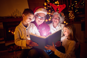 Wall Mural - Christmas magic book and family.