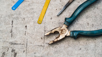 pliers and saw blades on cement board