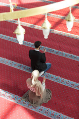 Wall Mural - Muslim man and woman praying in mosque