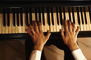 Canvas Print - Man hands playing piano, close up