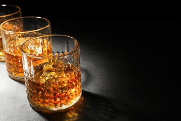 Wall Mural - Glasses of whisky on grey textured table closeup