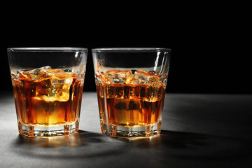 Poster - Glasses of whisky on dark background