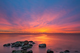 Fototapeta Zachód słońca - Vibrant Sunrise Seascape from a Jetty 