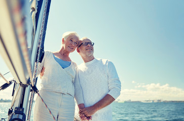 Poster - senior couple hugging on sail boat or yacht in sea