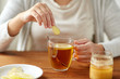 © Syda Productions - close up of ill woman drinking tea with ginger