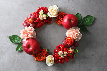 Wall Mural - Beautiful flowers wreath on grey textured background