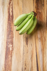 Bunch  ripe green bananas. Yellow leaves of a banana tree backgr