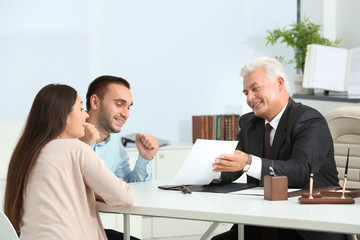 Wall Mural - Young couple with notary at office