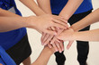 © Africa Studio - Team of friendly young people holding hands together