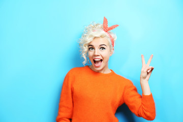 Portrait of funny emotional girl on blue background