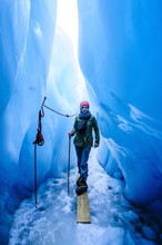 Woman Standing In An Ice Cave, Fox Glacier, Westland Tai Poutini National Park, South Island, New Zealand