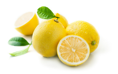 Wall Mural - Ripe juicy lemon with leaf isolated on white