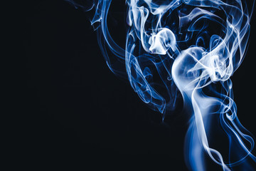 Artistic blue smoke on black background texture.