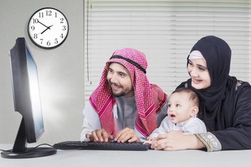 Wall Mural - Arabian family browsing the internet at home