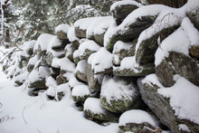 Stone Wall In Forest Covered In Snow