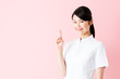 portrait of young asian nurse isolated on pink background