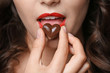 © Africa Studio - Girl eating chocolate, closeup