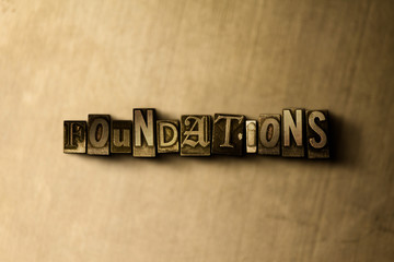 FOUNDATIONS - close-up of grungy vintage typeset word on metal backdrop. Royalty free stock illustration.  Can be used for online banner ads and direct mail.