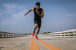 © Panumas - Man running sprinting on road. Fit male fitness runner during ou