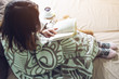© Artem - Woman wrapped in a warm blanket reading book