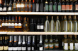 Shelves with alcohol bottles in supermarket