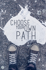Choose your own path motivational quote on urban asphalt backgro