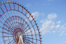 Red Ferris Wheel With Bright Clear Blue Sky