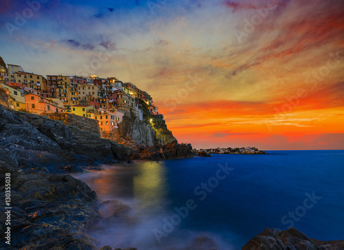 Cinque Terre colorful traditional houses on a rock over Mediterranean sea after sunset at the dusk, Manarola, , Italy, Ligurian Coast Poster
