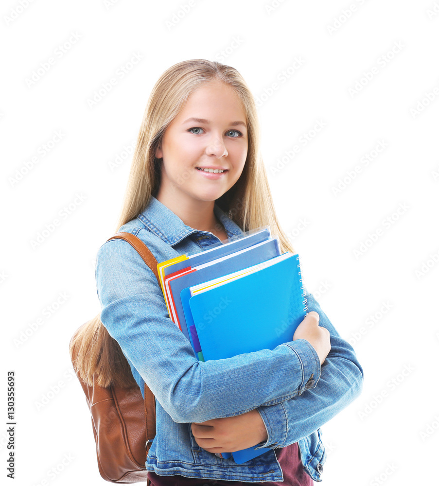 Beautiful teenager with backpack and books on white background