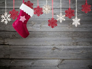 Christmas stocking hanging against wooden background