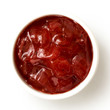 Red onion chutney in ceramic bowl isolated on white from above.