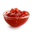 Red onion chutney in glass bowl isolated on white.