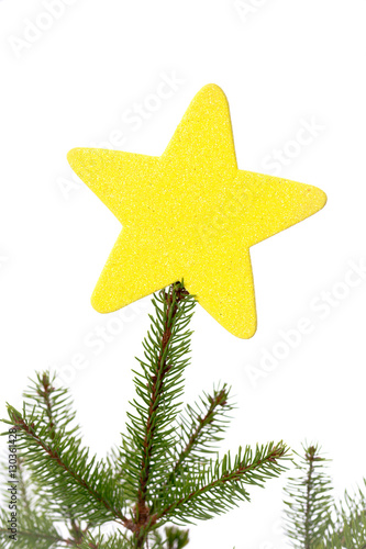gul glittrig julstjärna i toppen av en gran - Buy this stock photo ...